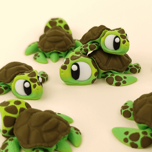 Articulated 3D‑printed sea turtle flexi toy with green shell