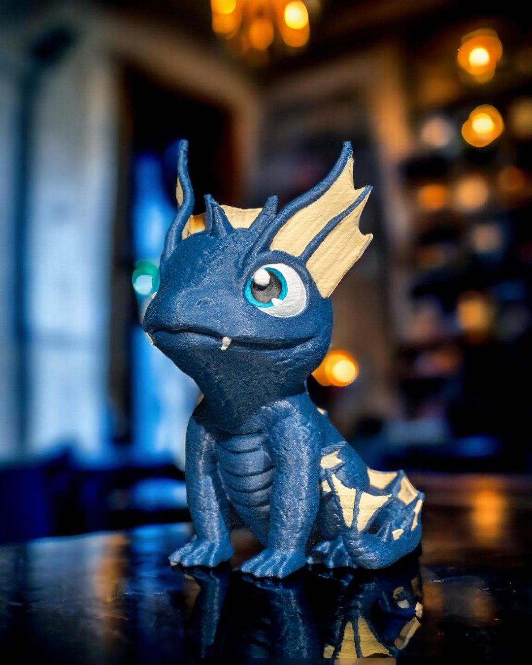 3D printed water dragon figure – lifestyle photo on tabletop with warm lights