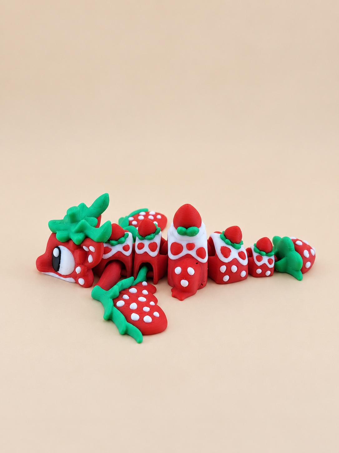 Side view of the articulated Strawberry Dragon showing its flexible body and strawberry details