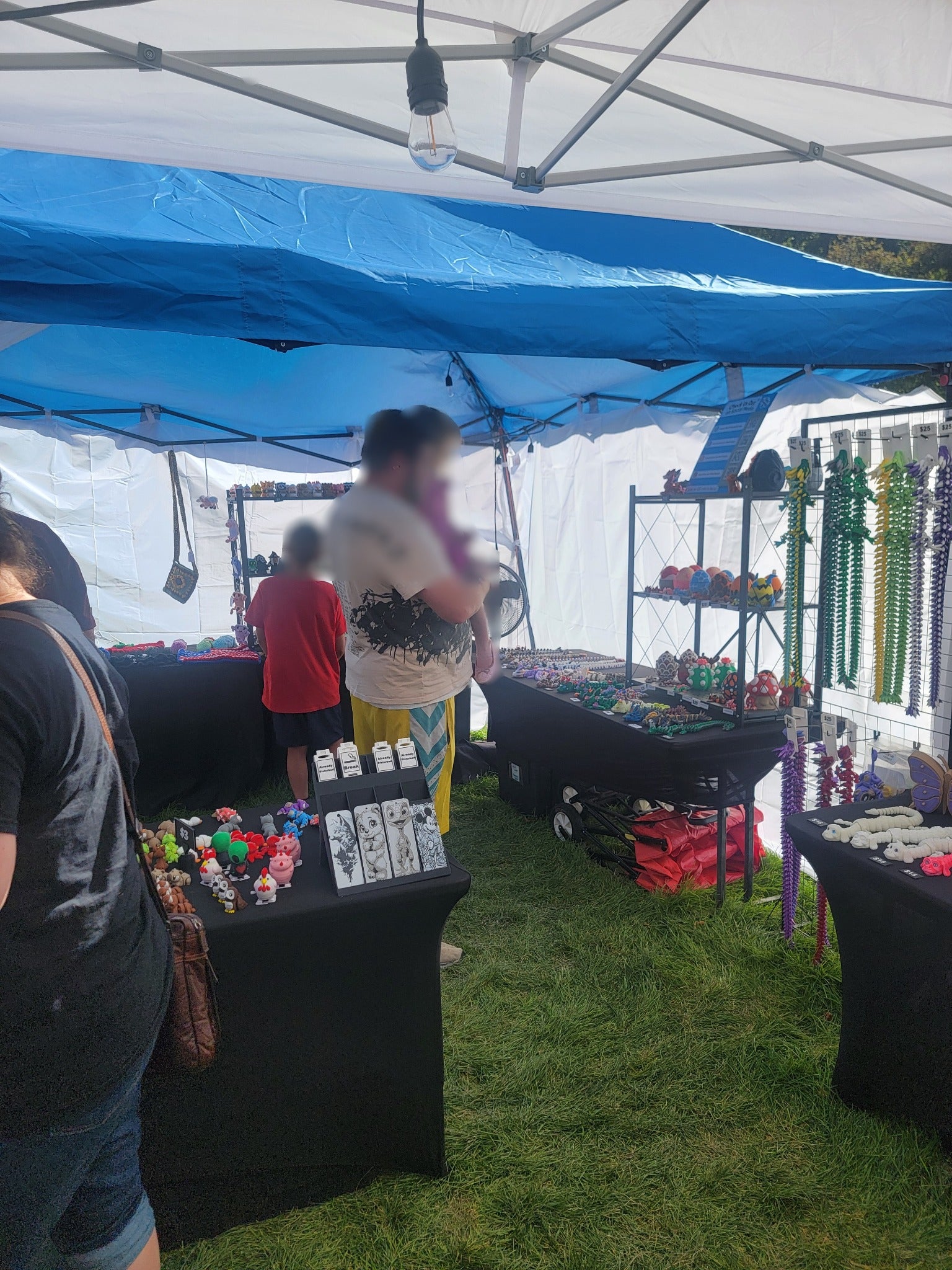 Shoppers browsing FlexiFriends3D dragons and minis at Onion Days in Payson
